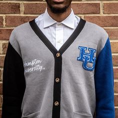 "Make a bold statement and wear your Hampton pride with this one-of-a-kind and comfortable cardigan sweater, perfect for any alumni, students or supporters. Made with the highest quality materials, this sweater is designed to keep you warm and cozy while representing Hampton. Features: - Official Hampton University logo embroidered on the chest - Large \"HU\" Logo Chenille patch - Classic cardigan design with a tortoise shell button-up front - Two front pockets (deep enough to fit a phone and other essentials) - Soft and durable fabric for long-lasting comfort - Available in a range of sizes to fit everyone - Versatile and fashionable, perfect for both casual and formal occasions Discover More Officially licensed Hampton University Apparel Celebrating Black excellence. Building legacy. Joi Collegiate Cotton Long Sleeve Cardigan, Collegiate Long Sleeve Cotton Cardigan, Casual Winter Cardigan For College, Collegiate Long Sleeve Cardigan For College, Long Sleeve Collegiate Cardigan For College, Winter College Cardigan, Varsity Cardigan For Winter College Season, Varsity Style Cardigan For College In Winter, Varsity Style Winter Cardigan For College