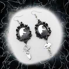 Step into the realm of whimsical and thought-provoking accessories with our captivating Broken Mirror Earrings, perfectly suited for those who revel in gothic style. These unique earrings are a testament to the beauty found in imperfection, inspired by the delicate balance between fragility and resilience. Crafted with care and attention to detail, each earring features a miniature hand mirror, its surface elegantly cracked and shattered, evoking an aura of mystery and allure. From the broken mi Black Fantasy Style Pierced Earrings, Black Fantasy Earrings, Black Fantasy Style Earrings, Gothic Black Single Earring, Gothic Single Earring For Party, Fantasy Style Pierced Earrings For Party, Black Fantasy Dangle Jewelry, Black Gothic Drop Plug Earrings, Gothic Drop Earrings Pierced