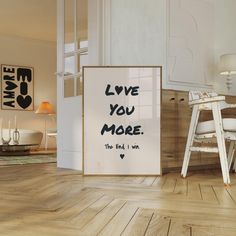 a white chair sitting next to a poster on top of a hard wood floor in a living room