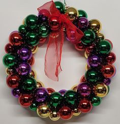 a colorful christmas wreath hanging on a wall