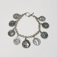 This bracelet is lightweight and 7.5 inches long. The coins are silver plated pewter that has been lacquered for a long lasting finish. We use a high-quality plating for a long-lasting finish. The bracelet has a toggle bar closure. This bracelet will ship in a jewelry box with an information card. Besides trade, ancient coins were also used to promote rulers, to celebrate victories, or to bind peoples together. Based on a country's purpose or religion, these coins featured the heads of gods or t Symbolic Coin-shaped Collectible Jewelry, Symbolic Collectible Coin Jewelry, Coin Charm Bracelet, Information Card, Roman Coins, Alexander The Great, Ancient Coins, Charm Bracelets, Alex And Ani Charm Bracelet