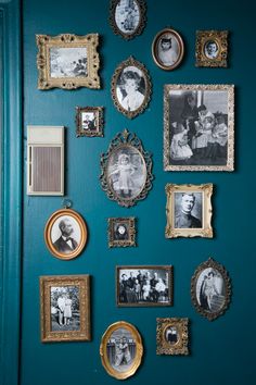 a blue wall with many pictures and frames hanging on it's side, including an old family photo