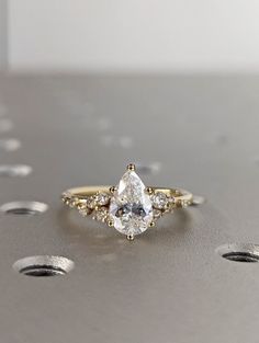 a close up of a diamond ring on a table