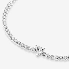 Bring elegance to your outfit with the Sparkling Pavé Tennis Bracelet. Hand-finished in sterling silver, this tennis bracelet is decorated with sparkling clear cubic zirconia. A large central heart-shaped stone punctuates a row of evenly sized pavé. The bracelet includes a lobster clasp for safe closure and can be adjusted to three lengths. Style it with other shimmering Pandora Timeless pieces for a classic look that stands out. - Pandora Sparkling Heart Tennis Bracelet - Sterling silver / Cubic Zirconia / Clear - Sz. 7.1 in Classic Silver Tennis Bracelet With Sparkling Details, Classic Silver Sparkling Tennis Bracelet, Classic Heart Cut Tennis Bracelet For Formal Occasions, Classic Silver Heart Bracelet With Cubic Zirconia, Classic Silver Cubic Zirconia Heart Bracelet, White Gold Heart Cut Tennis Bracelet For Formal Occasions, Heart Cut White Gold Tennis Bracelet For Formal Occasions, Formal White Gold Heart Tennis Bracelet, Formal White Gold Heart Bracelet With Cubic Zirconia