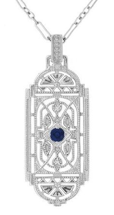 This stunning Art Deco blue sapphire pendant necklace in sterling silver features a vintage heirloom geometric filigree lozenge design, adorned with a nature inspired filigree leaves motif and light scattering millgrain edging for a wonderful finishing touch. At its center is a 0.15 carat royal blue sapphire ( September Birthstone ) in a secure 4 prong bead setting. Measuring approximately 1 3/4 inches high including the bail, by 11/16 inch wide, this beautiful original 1920's design sapphire ne Art Deco Filigree, Emerald Necklace Pendant, Filigree Pendant Necklace, Silver Necklace Simple, Geometric Pendant Necklace, Ruby Necklace Pendant, Blue Sapphire Pendant, Sapphire Necklace Pendants, Antique Filigree