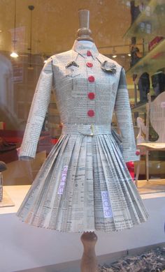 a dress made out of newspaper sitting on top of a table