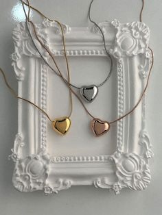 Add a touch of elegance with the beautiful Wendy necklace. Featuring a chubby metallic heart charm sliding along a delicate snake chain, this necklace adds a playful yet chic touch to any outfit. Whether you're dressing up or keeping it casual, this necklace offers style and sophistication for every day. The snake chain design requires extra care to prevent kinks and damage. Additionally, the chubby heart charm is prone to scratches, so please handle with care to maintain its pristine look. Mate Trendy Heart Pendant Charm Necklaces For Party, Trendy Rose Gold Heart Charm Necklaces, Trendy Rose Gold Charm Necklaces For Valentine's Day, Trendy Rose Gold Heart Charm Necklace, Trendy Rose Gold Heart Necklace, Party Charm Necklace With Heart Pendant And Adjustable Chain, Party Heart Pendant Charm Necklace With Adjustable Chain, Trendy Adjustable Snake Chain Necklace For Gift, Trendy Adjustable Snake Chain Necklace As Gift