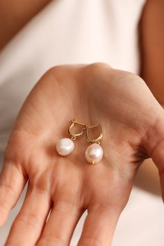 "Lovely Pearl Drop Earrings! These beautiful pearl drop earrings feature a unique design with the perfect combination of dangle and drop. Pearl jewelry perfect for daily use.. Our dainty gold earrings will admire you with vintage jewelry style. Our minimalist earrings may be gifts as wedding earrings, bridesmaid gifts, Mothers Day gifts, bridal earrings. 💖Dainty baroque pearl for yourself or for someone special in your life.. ✋ All our dangle earrings  %100 custom made by hand with Love and Care in our workshop! Nickel Free Handmade Jewelry High Quality Materials Standard Deliver in 8-12 Business Days *How to customize Order? 1- Select Color 2- Click \"Add to Cart\" 3- Checkout 4- Complete order MATERIAL GOLD-FILLED JEWELRY: - 14k Gold-Filled jewelry is made by bonding a solid layer of 14 Pear-shaped Wedding Hoop Earrings, White Pear-shaped Hoop Earrings For Wedding, Classic Wedding Hoop Earrings With Pearl Drop, Pear Shaped Hypoallergenic Pearl Wedding Earrings, White Hoop Earrings With Pearl Pendant For Wedding, White Pearl Pendant Hoop Earrings For Wedding, Single Pearl Earring For Wedding, Pear-shaped Pearl Pendant Bridal Earrings As Gift, Round Pearl Drop Earrings For Bridesmaid Gift