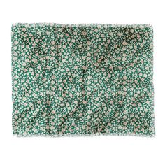 a green and white flowered cloth on a white background