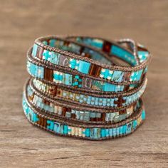 the turquoise and brown beaded bracelets are stacked on top of each other