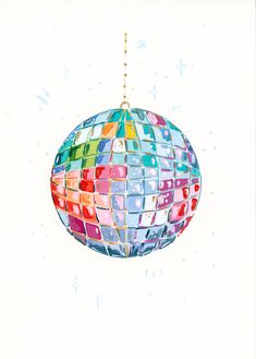 a colorful ornament hanging from a gold chain