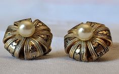 These exquisite earrings are like two round ornate pillows with a pearl centre. They are in very good vintage condition with minor wear on the clip-ons due to age.  These rare unique earrings are highly collectible for damascene lovers.  FREE SHIPPING to Canada and the U.S.  We also ship internationally, please contact us for shipping costs. We are not responsible for duty fees or delays. Vintage Gold Clip-on Earrings For Vintage Events, Antique Round Clip-on Earrings For Anniversary, Gold Vintage Clip-on Earrings For Vintage Events, Gold Vintage Clip-on Earrings, Vintage Round Pearl Earrings For Anniversary, Antique Clip-on Pearl Earrings For Wedding, Victorian Style Clip-on Pearl Earrings For Formal Occasions, Vintage Filigree Clip-on Earrings For Formal Events, Vintage Filigree Clip-on Earrings For Formal Occasions