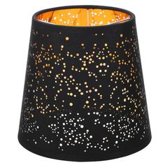 a black candle holder with gold dots on it