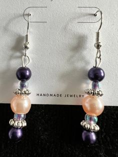 These beautiful lightweight glass and metal bead earrings are sure to add a beautiful accent to any wardrobe!  They offer just the right elegance to any outfit.   The color combination is magnificent with deep purple and pink beads combined with the silver accents. All jewelry is nickel free.   All of my earrings are made with nickel-free, hypoallergenic ear wires.  The earring backs are made of clear silicone.  The hooks themselves are silver plated. Earrings are approximately 1 1/2" in length Elegant Lavender Beaded Drop Earrings, Elegant Lavender Beaded Earrings, Adjustable Silver Earrings With Colorful Beads, Elegant Lavender Beaded Earrings With Dangling Beads, Nickel-free Pink Beaded Earrings, Elegant Multicolor Nickel-free Beaded Earrings, Pink Jewelry With Silver Beads For Party, Elegant Multicolor Czech Glass Beaded Earrings, Elegant Pink Czech Glass Earrings