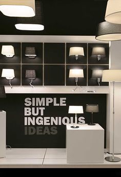 a store display with lamps and lights on the wall, along with an advertisement that reads simple but ingenious ideas