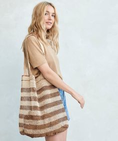 Natural Lao Vine Tote Natural Stripe This versatile and eco-friendly bag is perfect for beach days, grocery runs, and beyond. A completely natural product handcrafted from 100% kudzu vine fiber that grows wildly in northern Laos without any cultivation, irrigation or chemicals. Handcrafted from 100% kudzu vine fiber. Zero waste, organic, vegan, plastic-free, chemical-free, and Fair Trade. Due to the handmade nature of this bag, product may slightly vary as each one is unique. Please note that th Eco-friendly Handwoven Natural Crochet Bag, Fair Trade Jute Beach Bag For Daily Use, Fair Trade Jute Beach Bag, Fair Trade Natural Color Tote Beach Bag, Eco-friendly Sand Crochet Bag For Everyday Use, Eco-friendly Neutral Shoulder Bag For Beach, Eco-friendly Neutral Beach Bag For Summer, Eco-friendly Neutral Beach Bag For Vacation, Eco-friendly Natural Straw Market Bag