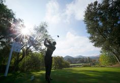 a man is playing golf in the sun