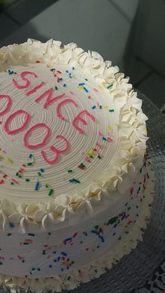 a birthday cake with white frosting and sprinkles that says 350 on it