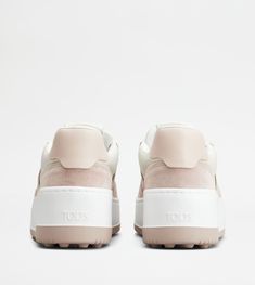 Characterized by a rubber platform outsole with its distinctive maxi rubber pebbles, these sneakers come with a basketball inspired upper. Crafted in soft leather with suede inserts and Tod's logo stamped on the side, they interpret a refined and feminine sporty style. White Leather Chunky Sneakers With Contrast Sole, White Leather Chunky Sneakers With Textured Sole, Pink Leather Chunky Sneakers With Rubber Sole, White Leather Platform Sneakers With Translucent Outsole, White Platform Sneakers With Branded Heel, Pink Leather High-top Sneakers With Textured Sole, White Leather Chunky Platform Sneakers, White Leather Platform Chunky Sneakers, Luxury White Platform Sneakers With Textured Sole