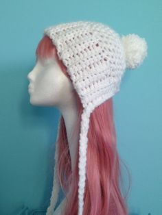 a white crocheted hat with pink hair