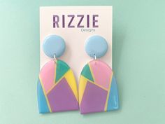 Featuring a geometric pastel pink, yellow and purple drop and blue top. Approximately 7cm long by 3.5cm wide. All Rizzie Design earrings have surgical steel posts. They are all designed and handmade by me (Libby), therefore you may receive a pair slightly different to the pair in this listing and they may have minor but unique imperfections. We do our best to capture the earrings true colours in our photographs, however, lighting and screens may vary the colours slightly. We hope you like them. Playful Purple Earrings For Gift, Playful Purple Earrings For Gifts, Colorful Retro Earrings For Gifts, Colorful Retro Earrings For Gift, Pink Geometric Earrings, Colorful Earrings As A Gift, Pastel Drop Earrings For Gifts, Colorful Handmade Modern Earrings, Pastel Handmade Earrings For Gifts