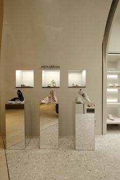 the inside of a shoe store with three mirrors