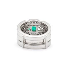 Gender: Ladies    Metal Type: 18K White Gold    Size: 5.5    Width: 2.85 mm    Ring measures approximately in width: 2.85 mm    Jacket measures in width: 8.50 mm    Weight: 15.69 grams    18K White Gold Diamond and Emerald Cocktail Ring with a soft-square shank. The ring is a size 5.5. The ring weighs a total of 15.69 grams. Engraved with "18K".    In Excellent Condition.    4-Prong Set in 18 Karat White Gold with:    One (1) natural, emerald-cut, step cut, emerald:    Species: Natural Beryl  Variety: Natural Emerald  Measurements: 8.66mm x 6.44mm x 3.83mm in depth.  Estimated Weight: 1.57 ct.  Cut Style: Crown Step Cut  Cut Style: Pavilion Step Cut  Color(s): Strongly Green  Clarity: Slightly Included (Type III)  Pavé set in 18 Karat White Gold with:    Fifty-four (54) round brilliant cut Jacket Ring, Emerald Cocktail Ring, Emerald Cocktail, Diamond Cocktail Ring, Gold Cocktail Ring, Contemporary Ring, Gold Cocktail, Step Cut, Diamond Cocktail Rings