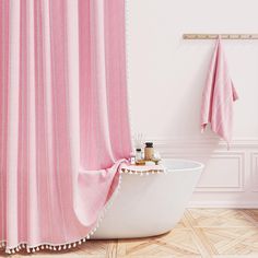 a bathroom with pink shower curtain and bathtub in the corner, next to a white wall