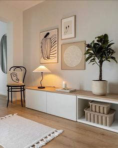 a living room filled with furniture and pictures on the wall