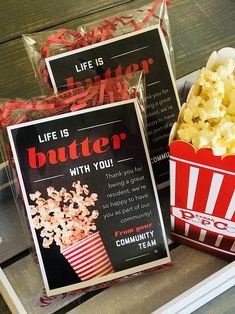 two boxes filled with popcorn sitting on top of a table