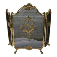 an ornately decorated fireplace screen with gold accents