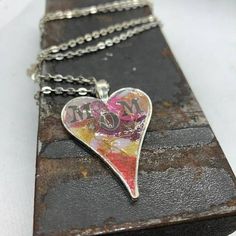 This Unique Resin Necklace is A Silver Heart Featuring Paper, Gold Thread and MOM in Red, Cranberry And White.  This Will Be a Perfect Gift and Accessory For Your Mom Or Special Lady... FREE STANDARD SHIPPING WITHIN THE U.S. Red Necklaces For Mother's Day Gift, Mother's Day Red Heart Pendant Necklace, Red Necklace For Mother's Day Gift, Multicolor Heart Necklace For Valentine's Day Gift, Red Heart Beads Necklace For Mother's Day, Mother's Day Red Heart Beads Necklace, Personalized Red Heart Necklace, Pink Heart Necklace As Gift For Mom, Multicolor Heart Necklace For Mother's Day Gift