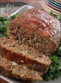 a loaf of meat sitting on top of a plate next to broccoli and carrots