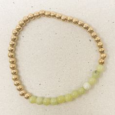 Our birthstone gemstone bracelets make a great gift for a loved one or for yourself. Featured here is our August gemstone bracelet. Peridot: One of the most potent healing crystals, Peridot helps to stabilize your moods and encourage you to bask in the glow of a life well-lived. Peridot resonates with the heart chakra, promoting an open heart, forgiveness, compassion, and unconditional love for yourself and others. Gold plated stainless steel beads strung on elastic cording for a comfortable fit Holistic Jade Beaded Bracelets As Gift, Jade Crystal Bracelet For Meditation, Holistic Jade Bracelet With Gemstone Beads, Holistic Jade Bracelets With Gemstone Beads, Holistic Hand-strung Jade Jewelry, Spiritual Gold Jade Beaded Bracelets, Gold Jade Beaded Bracelets For Spiritual Wear, Gold Jade Beaded Bracelets For Spiritual Purposes, Gold Jade Crystal Bracelet Gift