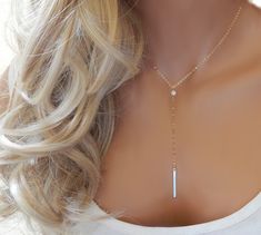 "OPAL LARIAT NECKLACE Our chic white opal and gold bar lariat. Simple and elegant. Photos do not do this opal justice! IT'S IN THE DETAILS ✦ 14K Gold Filled or Sterling Silver Chain and all components ✦ White Lab Opal (4mm) ✦ Gold or Silver Vertical Bar (26mm x 2mm) ✦ Necklace is shown at 17\" + 4\" Chain Drop ✦ Handmade to order, please allow 3-5 days for us to make your item before shipping UPGRADE TO A LOBSTER CLASP: ✦ https://www.etsy.com/listing/279125294 UPGRADE TO A MAGNETIC CLASP: ✦ http Opal Necklace Gold, Lingot D'or, Necklace Opal, Vertical Bar, Y Necklace, Silver Bar, October Birthstone, Silver Bars, Gold Bar