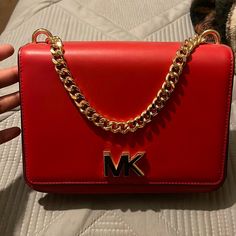 It’s A Red Mk Crossover Bag Never Used It Comes With The Dust Bag As Well Red Designer Shoulder Bag With Logo, Designer Red Shoulder Bag With Logo, Red Logo Crossbody Shoulder Bag, Michael Kors Red Rectangular Shoulder Bag, Michael Kors Handbags Black, Red Shoulder Bag With Silver-tone Hardware For Shopping, Red Crossbody Bucket Bag With Gold-tone Hardware, Red Square Shoulder Bag With Gold-tone Hardware, Red Shoulder Bag With Gold-tone Hardware For Shopping