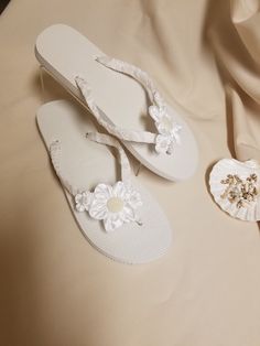 "Very simple Flat wedding sandals flipflop style 1/2\" heel. OFF-WHITE, ALSO CALLED DIAMOND WHITE. handmade flowers, the centers are a little darker than flowers; flowers are not white, flowers are Off-white. Very dressy and simple please look at the pictures. Sizes: Small: 5.5 - 6.5 Medium: 7-8 Large: 8.5 - 9.5, X-Large: 10 - 11 Please contact for any questions ON SIZING, or ANY other concerns. FINAL SALE, NO RETURNS, NO EXCHANGES, NO EXCEPTIONS." White Sandals For Beach Wedding In Spring, White Closed Toe Flip Flops For Vacation, White Open Toe Wedding Shoes For Beach Wedding, White Closed Toe Sandals For Beach Wedding, White Closed Toe Flip Flops For Beach, White Round Toe Beach Wedding Shoes, Adjustable White Sandals For Beach Wedding, Adjustable Open Toe Flip Flops For Beach Wedding, White Summer Flip Flops For Party