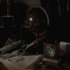 an old fashioned desk with books, papers and a clock