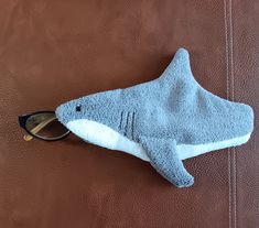 a stuffed shark with sunglasses on top of it