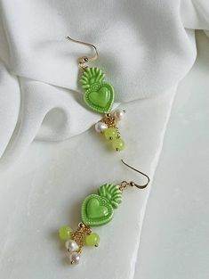 Sicilian earrings made of: - Sicily Ceramic sacred hearts (24 mm x 15 mm), green color; - Smooth stones (4 mm), green color; - Freshwater pearls (4 mm), white color, - 925 open hooks. Lenght : 6 cm / 2,36 inches * SHIPPING * Your order will be shipped within 1-3 business days from your purchase. You can choose between 2 shipping methods: STANDARD MAIL (NOT TRACEABLE) It is a cheap and fast shipping method, but NOT TRACEABLE. Chapeau Atelier is not responsible for any postal disruptions, delays o Sacred Hearts, Baroque Fashion, Sacred Heart, Red Coral, Heart Earrings, Sicily, Green Color, Deodorant, Green Colors