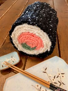 there is a sushi roll and chopsticks on the table