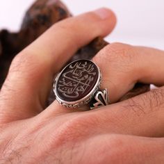 "This stunning Engraved Agate Islamic Zikir Ring features the beautiful calligraphy of two powerful zikir phrases: \"Ilahi Ente Maksudi\" and \"Rizake Matlubi\". The ring is made of red aqeeq stone, a precious gemstone that holds special significance in Islamic culture. This Sufi ring is perfect for Muslims looking to deepen their faith and spirituality, and it makes a thoughtful Eid jewelry gift for your loved ones. Handcrafted with care, this ring is a unique and meaningful piece that you'll c Traditional Carved Rings For Wedding, Round Rings With Inlay Perfect For Gifts, Gift Round Ring With Inlay, Traditional Oval Engraved Rings, Traditional Engraved Ring As Gift, Traditional Engraved Ring For Gift, Traditional Oval Engraved Ring As Gift, Traditional Oval Signet Ring As Gift, Traditional Carved Signet Ring Gift