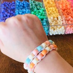 a child's hand wearing a bracelet made out of beads