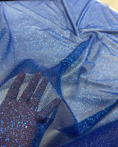 the fabric is blue and has silver speckles