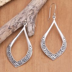 Traditional Balinese motifs enhance the beauty of these sterling silver dangle earrings by Dewa Arimbawa. With leafy formations, the accessory features a luminous appearance, making it an exquisite creation full of culture. Ornate Sterling Silver Teardrop Earrings As Gift, Ornate Sterling Silver Teardrop Earrings For Gift, Sterling Silver Intricate Teardrop Earrings, Sterling Silver Teardrop Earrings With Intricate Design, Ornate Sterling Silver Teardrop Earrings, Silver Teardrop Earrings With Intricate Design, Sterling Silver Teardrop Earrings With Oxidized Finish, Sterling Silver Teardrop Earrings For Gift, Bohemian Sterling Silver Teardrop Earrings With Intricate Design