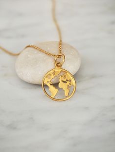 "Dainty Gold Globe Charm Necklace, Earth Necklace, Boho Jewelry, Globe Pendant, Globe Choker, World Map Necklace, Travel Gift, Symbolic Necklace, Gift for Her This Globe Necklace is made with a 14k Gold Filled Chain and a Gold Plated Sterling Silver Map Charm. A must-have for anyone who loves this beautiful world of ours. Keep our planet close to your heart with this necklace - a globe world map pendant on a stunning dainty chain. The length of the necklace can be chosen by you; the available le Earth Necklace, Globe Necklace, Necklace Travel, World Map Necklace, Gold Globe, Map Pendant, Symbol Necklace, Map Necklace, Dainty Chain