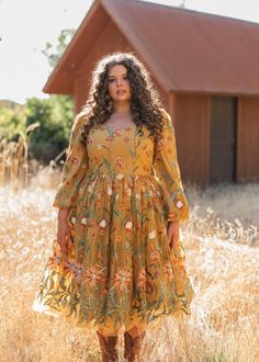 Golden Glow The Marigold Dress exudes a charming country chic aesthetic with its rich, mustard yellow hue and intricate floral embroidery. The dress features a flattering scoop neckline and long, sheer sleeves adorned with delicate botanical patterns. The voluminous skirt, with its layers of tulle, enhances the dress with a whimsical flair that beautifully captures the essence of rustic elegance and timeless style. Scoop neckline Back zipper Elastic full puff sleeve True to size Model Details Content + Care 100% Polyester Hand Wash Only Hang Dry Try-On Video Marigold Dress Try-On Video XS & XL Plus Size Dresses Modest, Gold Floral Embroidery Dress For Spring, Country Chic Aesthetic, Yellow Plus Size Dresses, Marigold Dress, Voluminous Skirt, Sewing Projects Clothes, Chic Aesthetic, Golden Glow