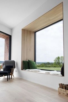 a living room filled with furniture and lots of window sills on top of wooden floors