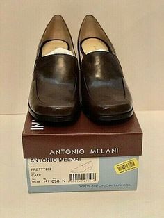 This is a pair of Antonio Melani Classic Pump new in box Size 9N, the color is café with 2.50 inch heel. They are made in Brazil comfy inner soles with leather soles with non-skid nubs. Brown Square Toe Heels With Rubber Sole, Brown Leather Shoes With Square Toe And Medium Width, Brown Leather Shoes With Medium Width And Square Toe, Brown Square Toe Heels For Business, Office Slip-on Brown Heels, Brown Slip-on Heels For Formal Occasions, Brown Loafers For Formal Occasions, Formal Brown Slip-on Heels, Brown Square Toe Leather Shoes For Formal