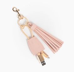 a pink key chain with tassels attached to it